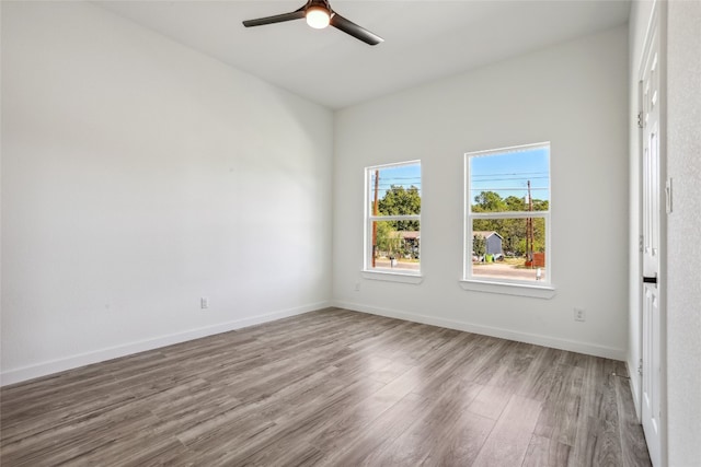 spare room with hardwood / wood-style floors and ceiling fan