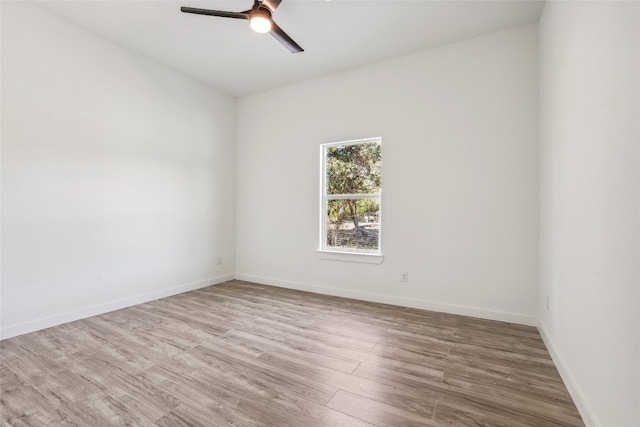 spare room featuring wood-type flooring and ceiling fan