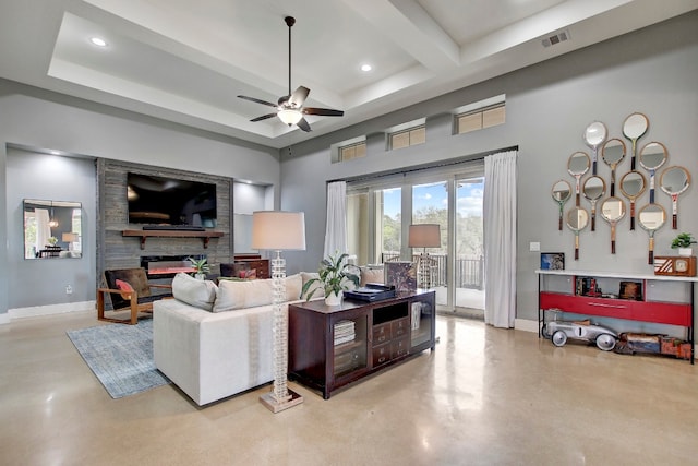 living room with ceiling fan and a large fireplace