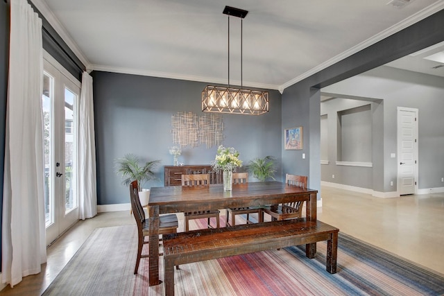 dining room featuring a wealth of natural light, crown molding, french doors, and a notable chandelier