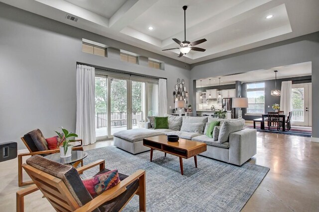 living room featuring french doors, beam ceiling, a wealth of natural light, and ceiling fan