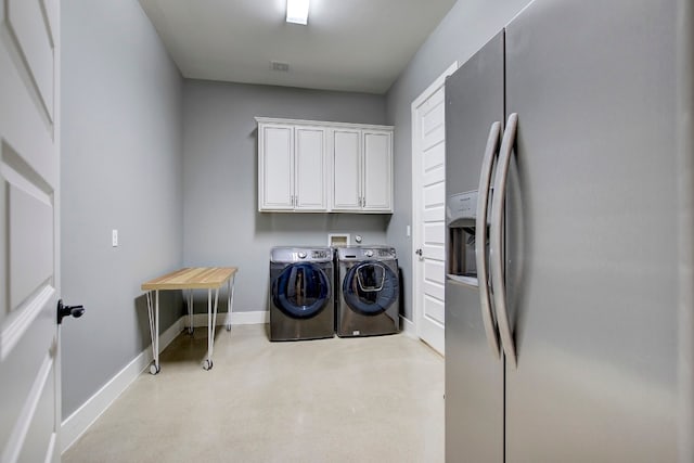 laundry area with light colored carpet, cabinets, and independent washer and dryer