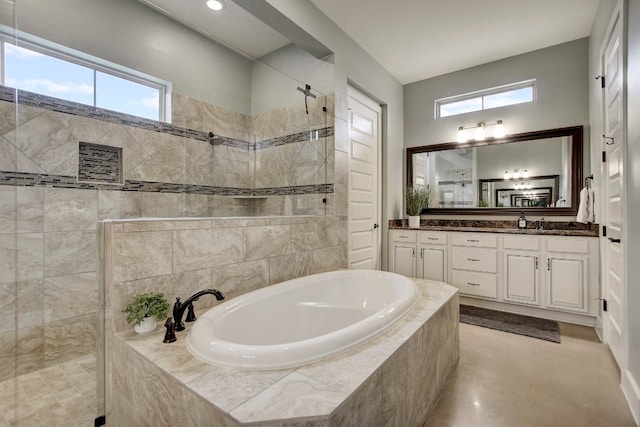 bathroom with plus walk in shower, vanity, and a healthy amount of sunlight