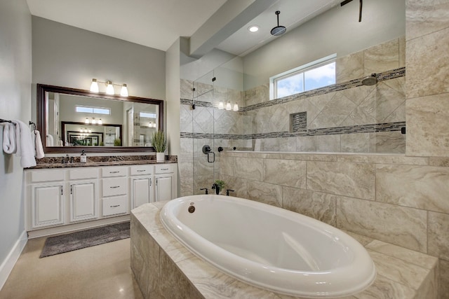 bathroom with vanity and independent shower and bath