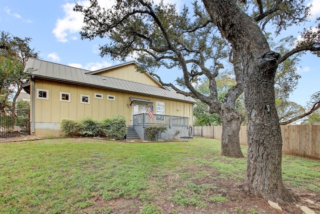 back of house with a lawn