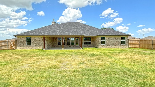 rear view of house with a yard and a patio area