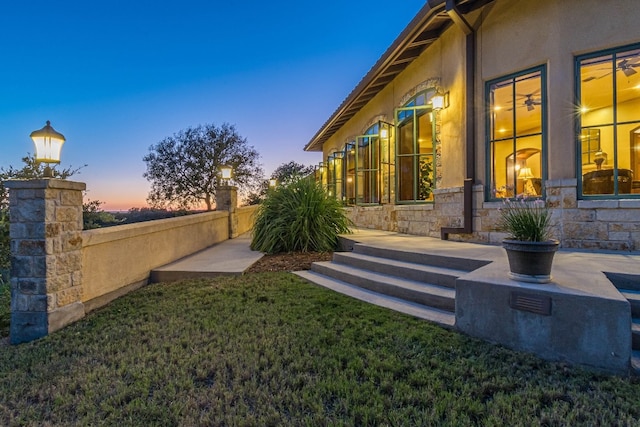 yard at dusk with a patio