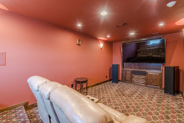 cinema room featuring dark colored carpet