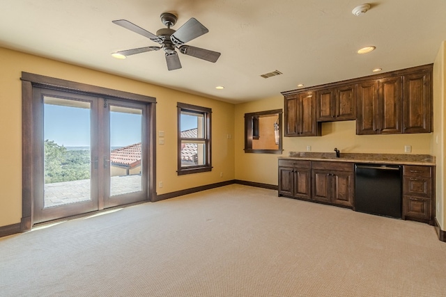 kitchen featuring dishwasher, light colored carpet, french doors, and sink