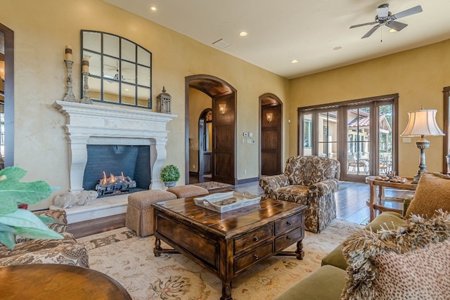 living room with light hardwood / wood-style floors and ceiling fan