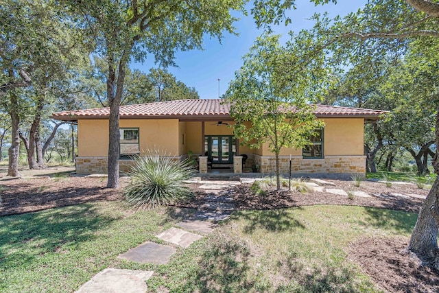 view of front of home with a front yard and french doors