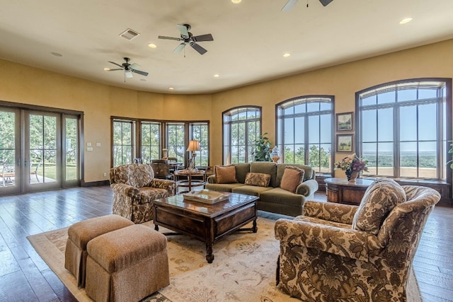 living room with ceiling fan and light hardwood / wood-style flooring