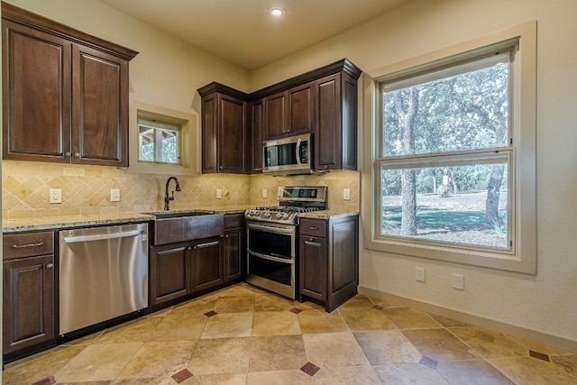 kitchen featuring plenty of natural light, stainless steel appliances, and tasteful backsplash