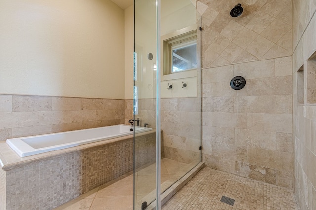 bathroom with tile patterned flooring and separate shower and tub