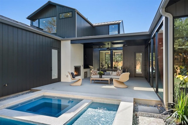 2606 Cavileer Ave, Austin, TX 78757 - back of house with ceiling fan, a patio, an outdoor living space with a fireplace, an in-ground hot tub, and an outdoor pool