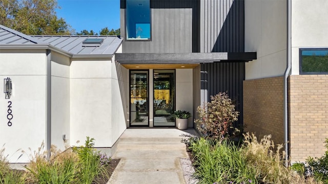 2606 Cavileer Ave, Austin, TX 78757 - doorway to property with a standing seam roof, brick siding, and a metal roof