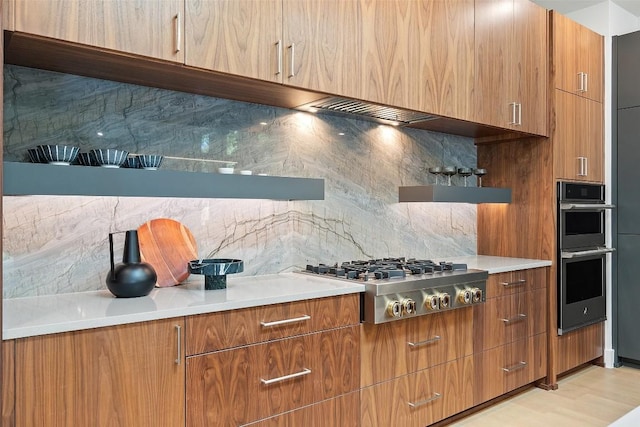 2606 Cavileer Ave, Austin, TX 78757 - kitchen featuring appliances with stainless steel finishes, backsplash, and brown cabinetry