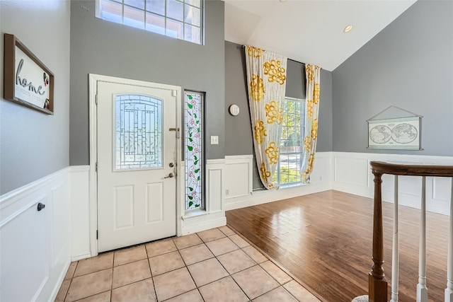 entrance foyer featuring light wood-type flooring and high vaulted ceiling