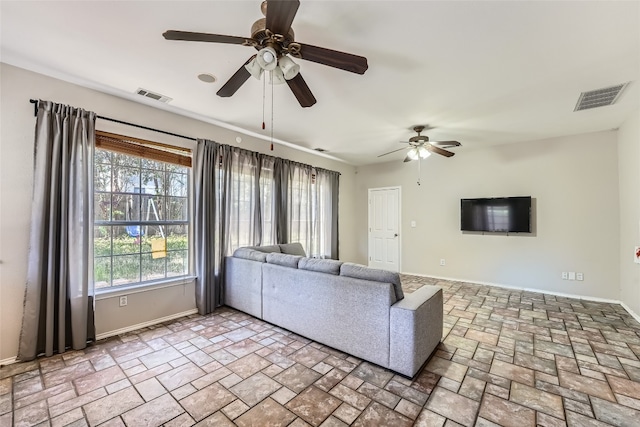 unfurnished living room with ceiling fan