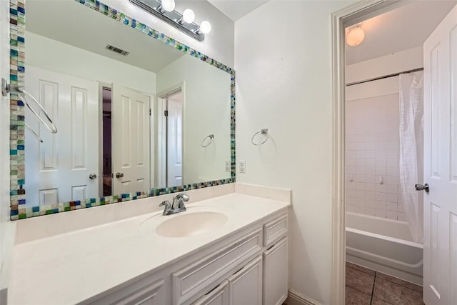 bathroom with tile patterned flooring, vanity, and shower / tub combo