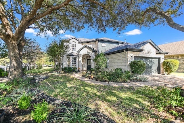 view of front of house with concrete driveway, a garage, stone siding, and a front lawn