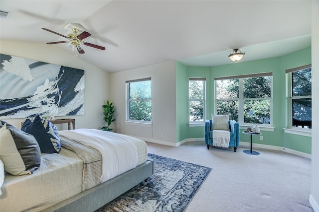 bedroom featuring multiple windows, ceiling fan, carpet, and lofted ceiling