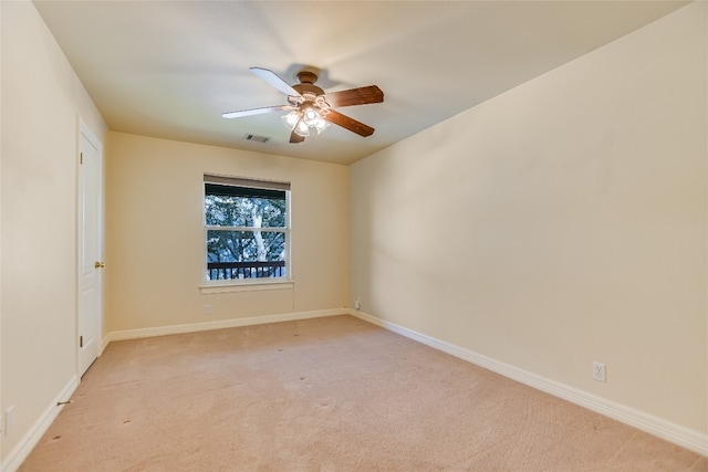 carpeted empty room featuring ceiling fan