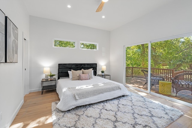 bedroom with multiple windows, access to outside, ceiling fan, and light hardwood / wood-style floors