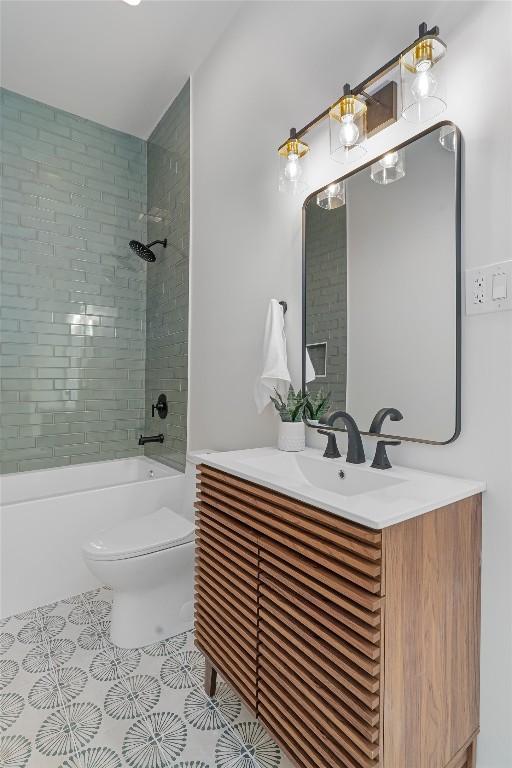 1207 Lexington St, Taylor, TX 76574 - bathroom featuring toilet, washtub / shower combination, vanity, and tile patterned flooring