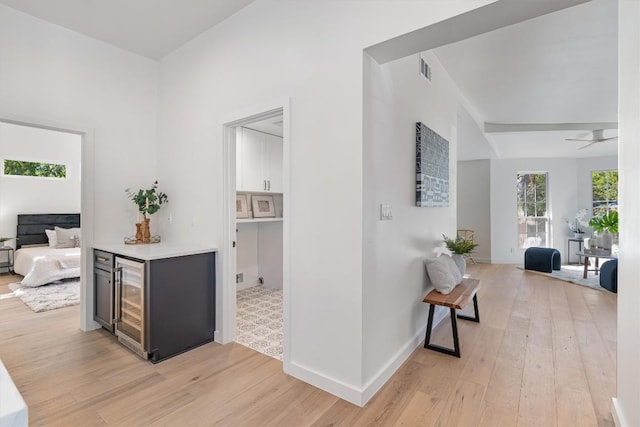 1207 Lexington St, Taylor, TX 76574 - corridor featuring light wood-type flooring, beverage cooler, and baseboards
