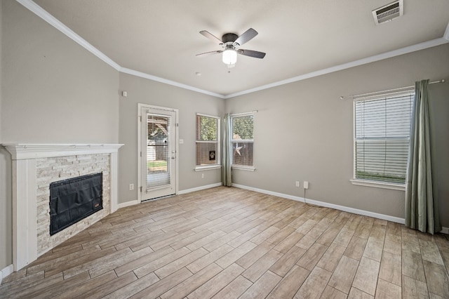 unfurnished living room featuring ceiling fan, a fireplace, light wood-type flooring, and crown molding