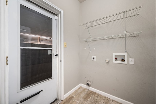 washroom featuring electric dryer hookup, gas dryer hookup, light hardwood / wood-style flooring, and washer hookup