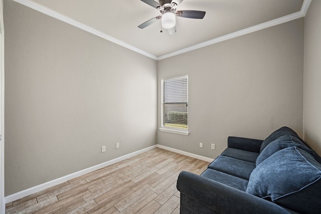 sitting room with ceiling fan, light wood-type flooring, and crown molding