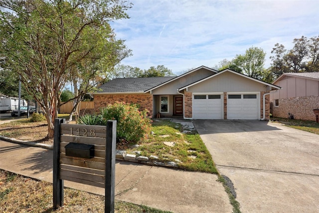 single story home featuring a garage, brick siding, and driveway