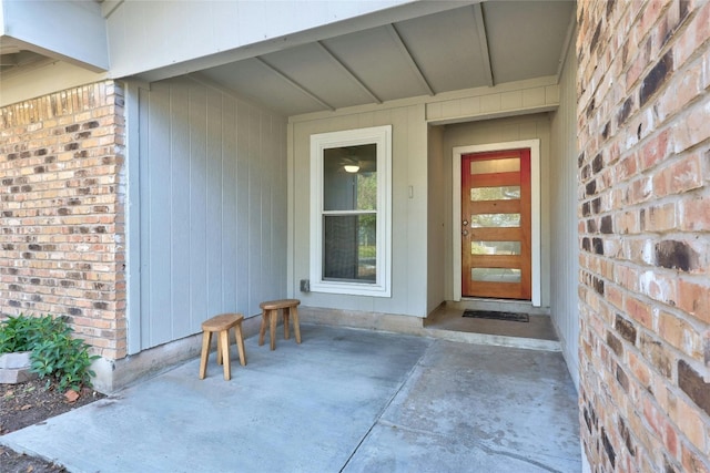 doorway to property with brick siding