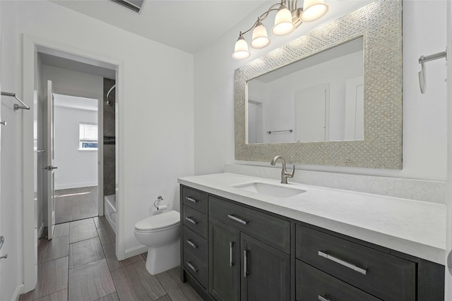 bathroom featuring toilet, bathing tub / shower combination, visible vents, and vanity