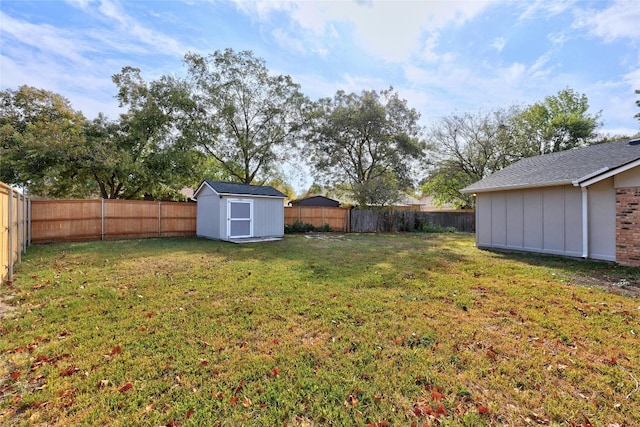 view of yard with a storage unit, an outdoor structure, and a fenced backyard