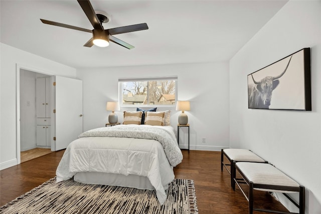 bedroom featuring dark wood-type flooring, a ceiling fan, and baseboards