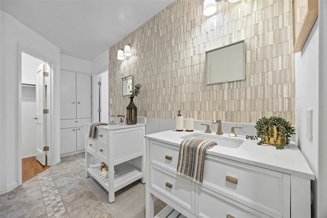 bathroom with tile patterned flooring, a sink, and tile walls