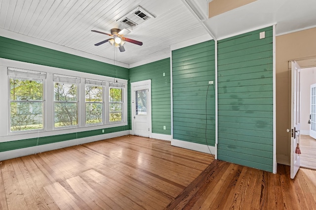 unfurnished sunroom with ceiling fan