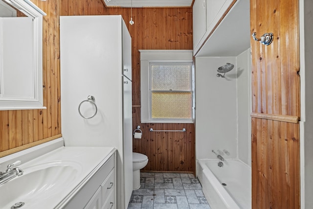 full bathroom featuring  shower combination, vanity, toilet, and wooden walls