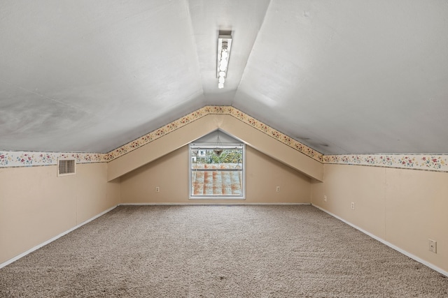 additional living space with carpet and lofted ceiling