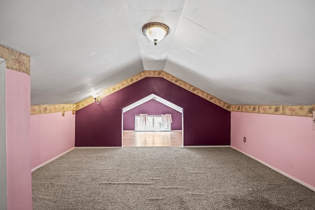 bonus room with carpet flooring and lofted ceiling