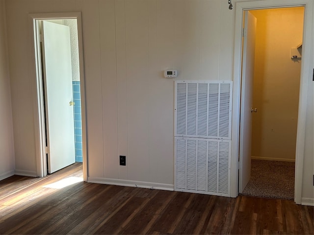 unfurnished bedroom with dark hardwood / wood-style floors and a closet