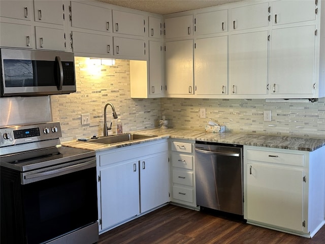 kitchen featuring sink, white cabinetry, stainless steel appliances, and dark wood-type flooring