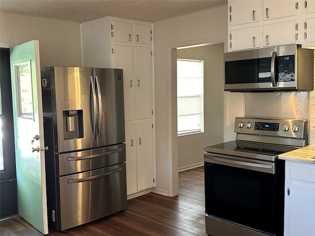 kitchen featuring white cabinets, dark wood-type flooring, a textured ceiling, and appliances with stainless steel finishes