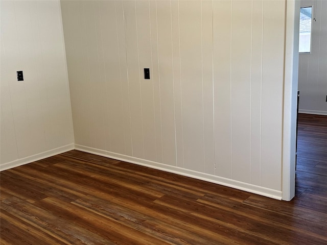 unfurnished room featuring dark wood-type flooring