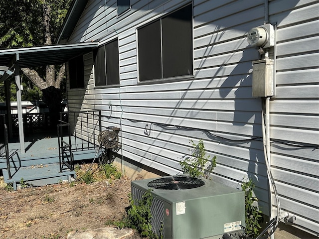 view of side of property with central air condition unit