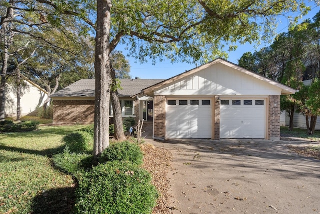 ranch-style home with a front yard and a garage