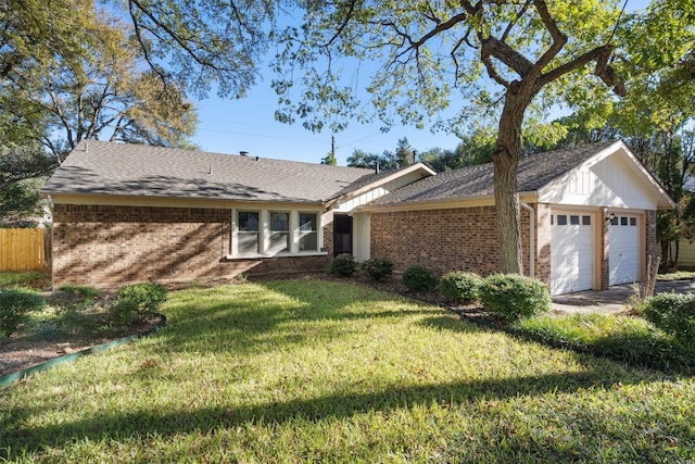 single story home featuring a garage and a front lawn